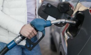 044043600_1661742697-woman-filling-up-car-gas-station